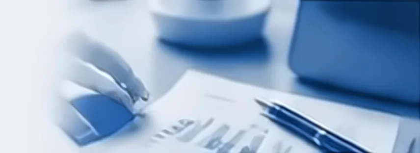 Hand reviewing printed financial charts with a pen